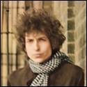 A person with curly hair wearing a scarf
Description automatically generated