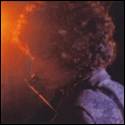 A person with curly hair and a pipe
Description automatically generated