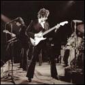 A group of men playing guitar on stage
Description automatically generated