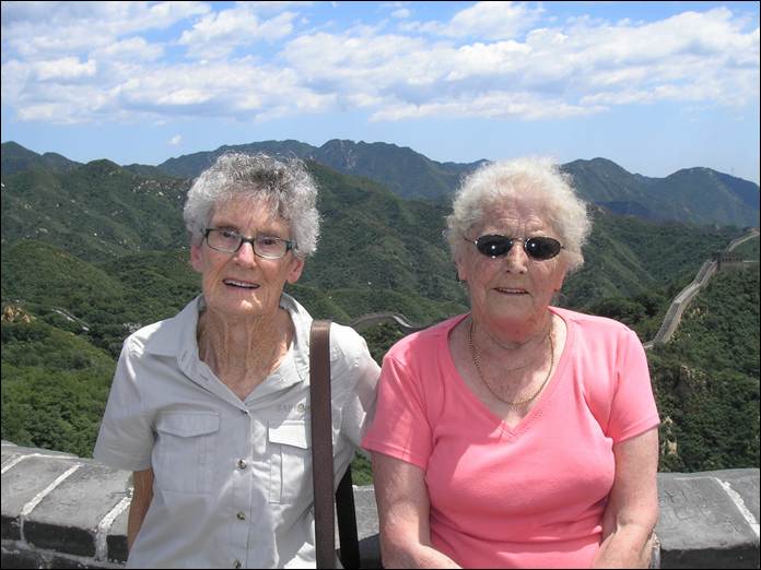 A couple of older women posing for a picture

AI-generated content may be incorrect.
