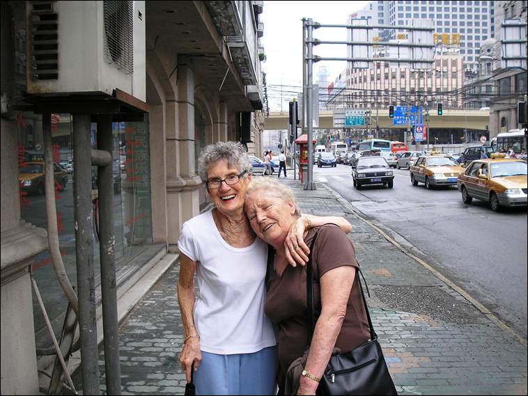 A couple of women standing on a sidewalk

AI-generated content may be incorrect.