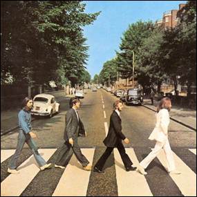 A group of men crossing a street
Description automatically generated
