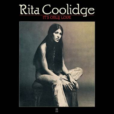 A person sitting on a stool
Description automatically generated