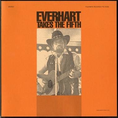 A person playing guitar on an orange cover

Description automatically generated