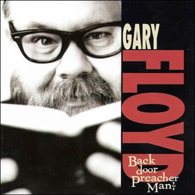 A person with glasses and a beard holding a book

Description automatically generated