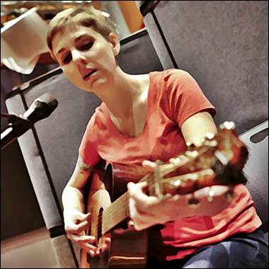 A person playing a guitar

Description automatically generated