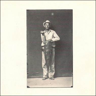 A person holding a fish
Description automatically generated