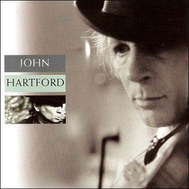 A person wearing a hat and a violin
Description automatically generated