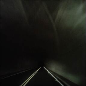 A dark tunnel with a road and light
Description automatically generated with medium confidence