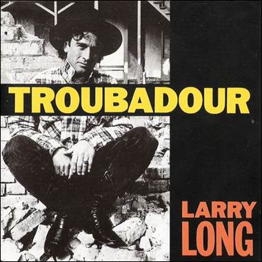 A person sitting on a brick wall

Description automatically generated