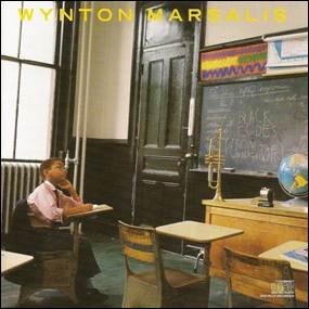 A child sitting at a desk in a classroom
Description automatically generated