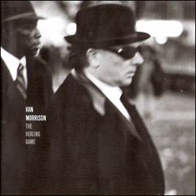 A person in a suit and hat
Description automatically generated