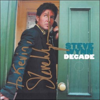 A person in a black jacket holding a phone

Description automatically generated