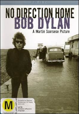 A person standing on a road with a car in the background
Description automatically generated