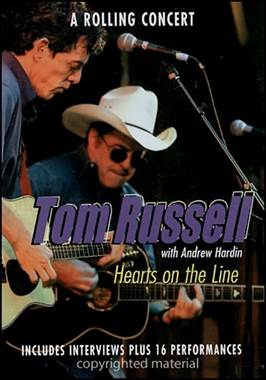 A person playing guitar with another person in cowboy hat
Description automatically generated