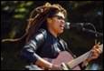 A person playing guitar and singing

Description automatically generated with medium confidence