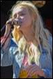 A person singing into a microphone

Description automatically generated