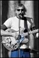 A person playing guitar with a microphone

Description automatically generated with low confidence