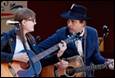 A person and person playing guitar

Description automatically generated with medium confidence