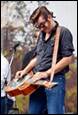 A person playing a guitar

Description automatically generated