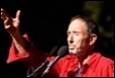 A person in a red shirt raising his hand

Description automatically generated with medium confidence
