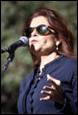 A person speaking into a microphone

Description automatically generated