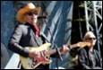 A person playing guitar on stage

Description automatically generated with low confidence