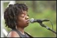 A person singing into a microphone

Description automatically generated