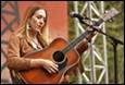 A person playing a guitar

Description automatically generated