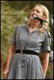 A person singing into a microphone

Description automatically generated