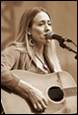 A person singing into a microphone

Description automatically generated