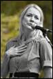 A person speaking into a microphone

Description automatically generated