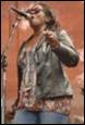 A person singing into a microphone

Description automatically generated