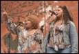 A group of women singing into microphones

Description automatically generated