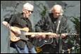 A group of men playing guitars

Description automatically generated