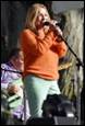 A person singing into a microphone

Description automatically generated