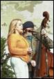 A person and person playing a cello

Description automatically generated