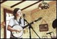 A person playing a banjo

Description automatically generated