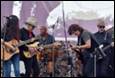 A group of people playing instruments

Description automatically generated
