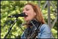 A person singing into a microphone

Description automatically generated