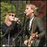 A person and person singing into microphones

Description automatically generated