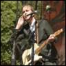 A person playing a guitar

Description automatically generated