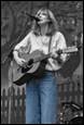 A person playing a guitar

Description automatically generated