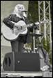 A person playing a guitar

Description automatically generated