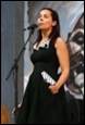 A person singing into a microphone

Description automatically generated with medium confidence
