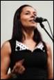 A person singing into a microphone

Description automatically generated