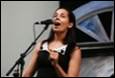 A person singing into a microphone

Description automatically generated