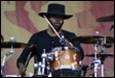 A person playing a drum set

Description automatically generated