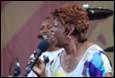 A person singing into a microphone

Description automatically generated with medium confidence