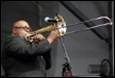 A person playing a trumpet

Description automatically generated